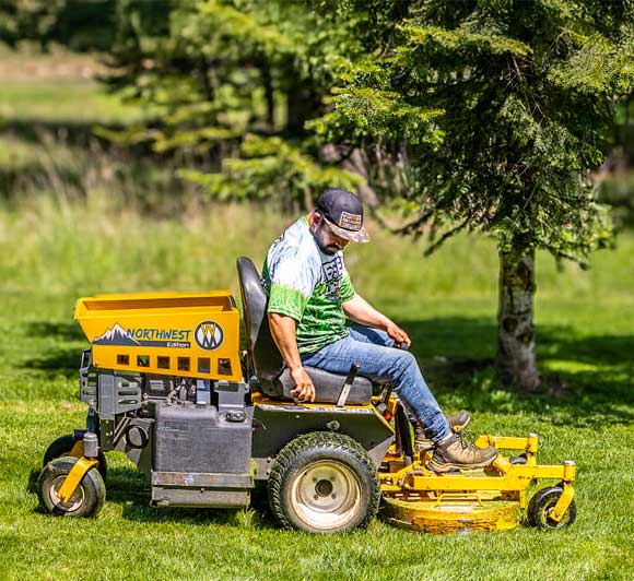 Messer Lawn Care employee mowing the laawn